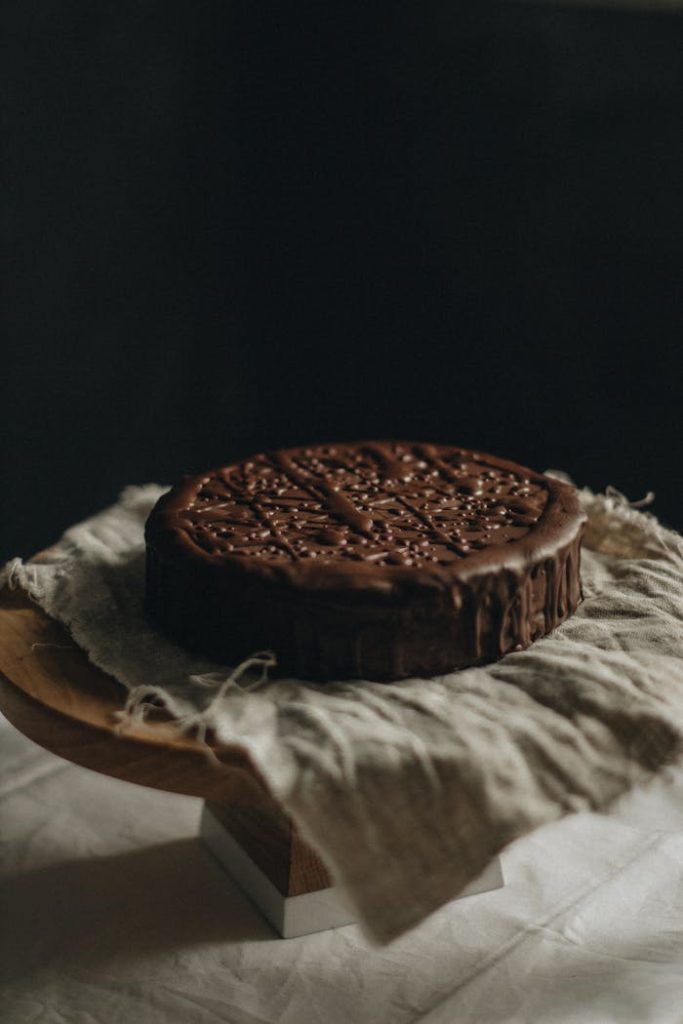 chocolate-cake-2067436 Delicious chocolate cake placed on rustic linen, ideal for dessert photography.
