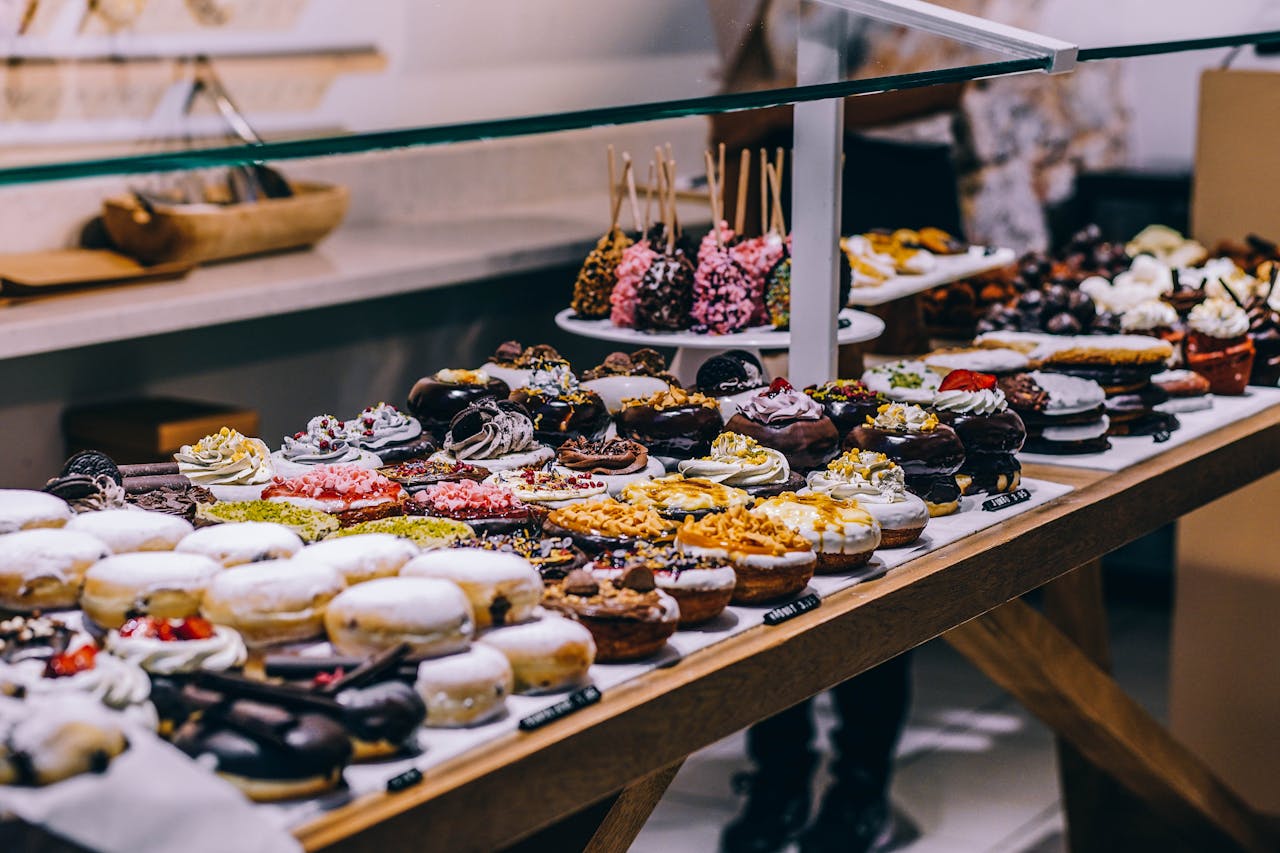 our-story-02 A tempting display of various donuts and pastries in a bakery. Ideal for food lovers and culinary enthusiasts.