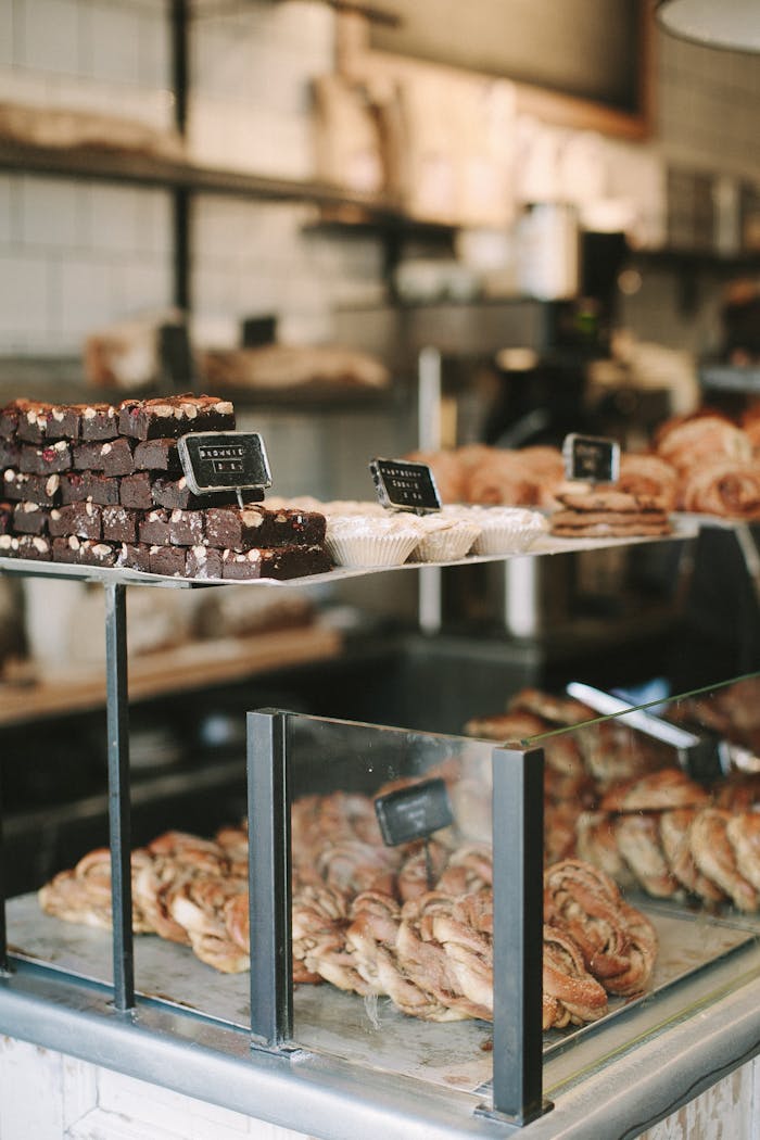 collection-05 Delicious pastries and brownies displayed in a quaint English bakery. Perfect for sweet cravings.
